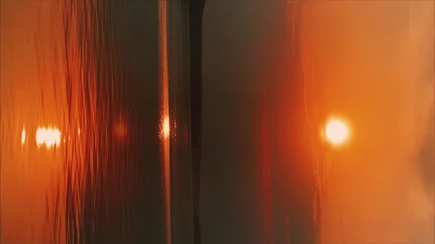A solar eclipse during a mesmerizing fiery sunset.  動画素材 250527082