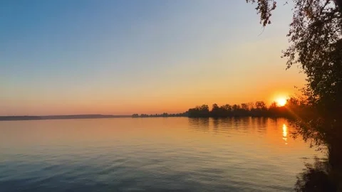 A solar eclipse during a mesmerizing fiery sunset. Majestic sunset or sunrise la Stock Footage 251651203