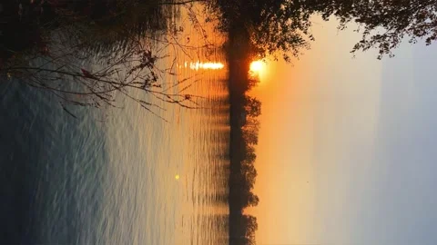 A solar eclipse during a mesmerizing fiery sunset. Majestic sunset or sunrise la Stock Footage 251651450