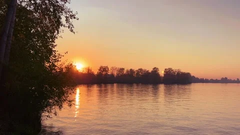 A solar eclipse during a mesmerizing fiery sunset. Majestic sunset or sunrise la Stock Footage 251651895