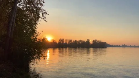 A solar eclipse during a mesmerizing fiery sunset. Majestic sunset or sunrise la 動画素材 251652547
