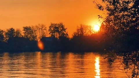 A solar eclipse during a mesmerizing fiery sunset. Majestic sunset or sunrise la Stock Footage 251652647