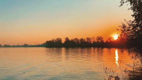 A solar eclipse during a mesmerizing fiery sunset. Majestic sunset or sunrise la Stock Footage 251655116