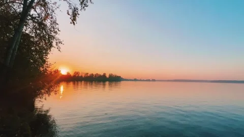 A solar eclipse during a mesmerizing fiery sunset. Majestic sunset or sunrise la Stock Footage 251655719