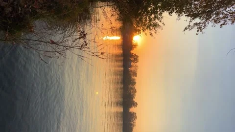 A solar eclipse during a mesmerizing fiery sunset. Majestic sunset or sunrise la Stock Footage 251655876