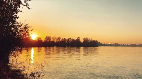 A solar eclipse during a mesmerizing fiery sunset. Majestic sunset or sunrise la Stock Footage 251656732