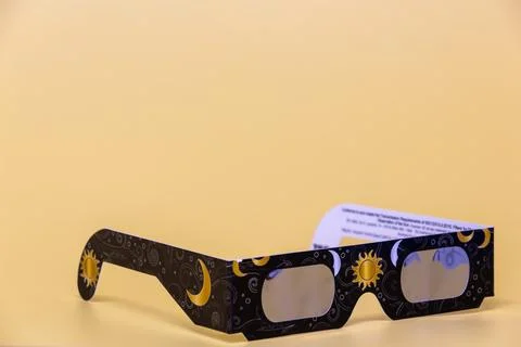 Solar eclipse glasses protecting eyes during astronomical event Stock Photos