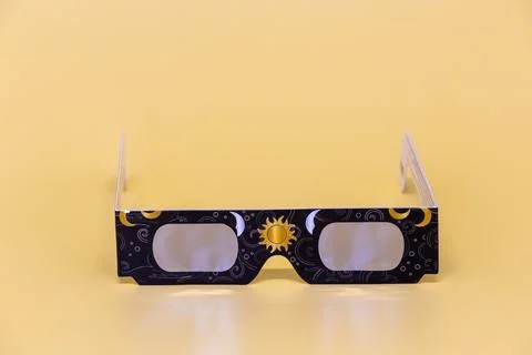 Solar eclipse glasses protecting eyes during celestial event Stock Photos