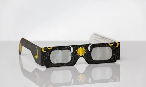 Solar eclipse glasses protecting eyes during celestial event Stock Photos