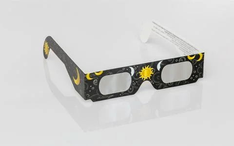 Solar eclipse glasses protecting eyes during celestial event Stock Photos
