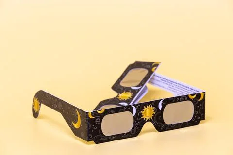 Solar eclipse glasses providing eye safety during astronomy event Stock Photos