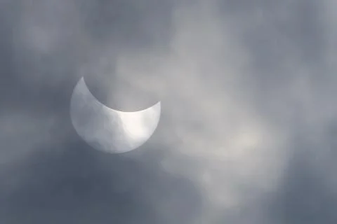 Solar Eclipse in the gray clouds Stock Photos