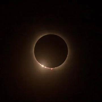 Solar eclipse with the light being seen through lunar canyons. Stock Photos