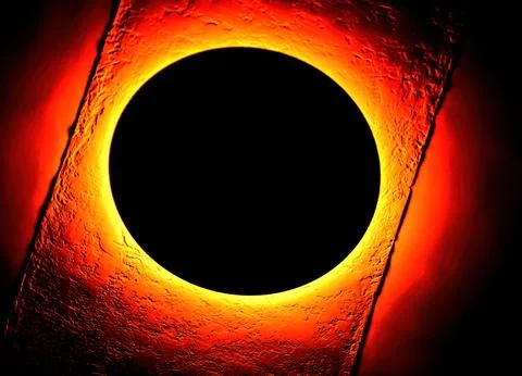 A solar eclipse observed from below, revealing a dark circle surrounded by a Stock Photos
