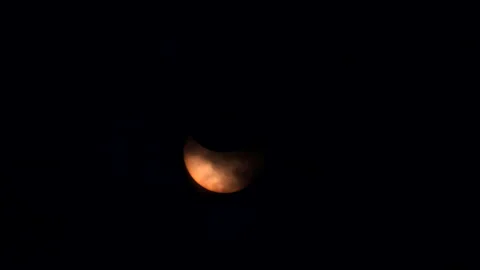 Solar eclipse occurs over the Midtown Manhattan skyscrape in New York City Stock Footage 277875809
