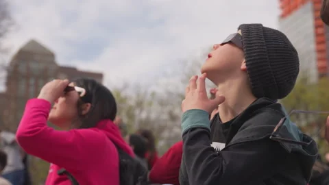 Solar eclipse occurs over the Midtown Manhattan skyscrape in New York City Video stock 277876899