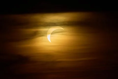 Solar eclipse over the landscape, showing dark lunar silhouette gliding acros Fotos de archivo