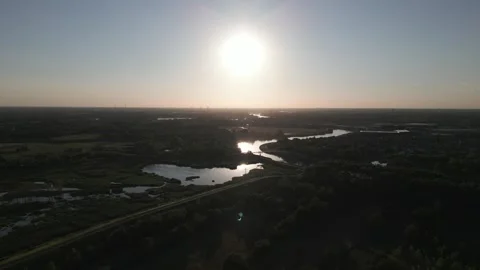 Solar eclipse over rural fields and ponds near Mechelen, Belgium Stock Footage 346352676