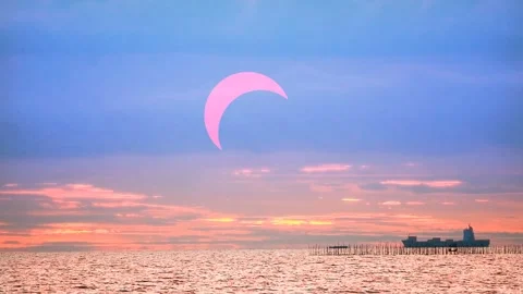 Solar eclipse red sunset on the ocean with cargo ship and red orange yellow.. 動画素材 273429337