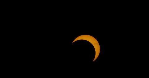 Solar eclipse with the remains of a jet’s contrail. Fotos Stock