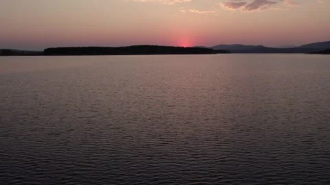 Solar eclipse setting over the Cuerda del Pozo Reservoir in Soria Видео 342554419