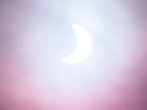 Solar eclipse, soft artistic background. White, blues and pinks. 写真素材