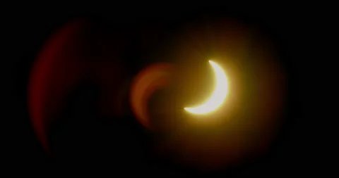 Solar eclipse of the sun with eerily defined crescent shaped lens flares. Stock Footage 230599421