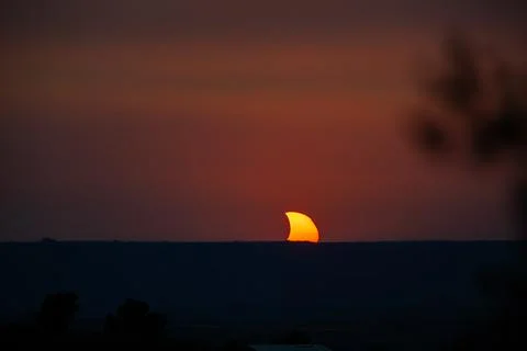 Solar eclipse sun setting over horizon in Lleida, Spain Stock Photos