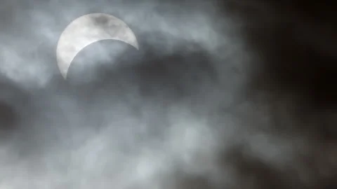Solar Eclipse totality moment in the dark clouds afternoon at April 8 2024 .. Stock Footage 273098635