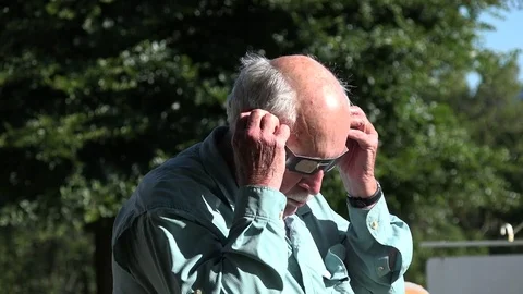 Solar eclipse watched by elderly man Stock Footage 79293117