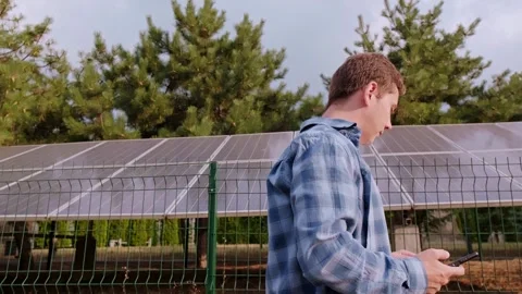 Solar energy engineer calculating efficiency and optimizing solar panel performa Stock Footage 300250190