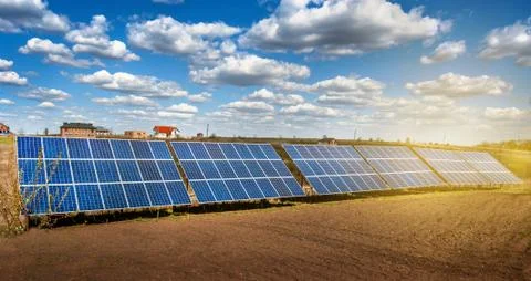 Solar energy panel system on plowed field and sunlight at sky with beautiful  Stock Photos