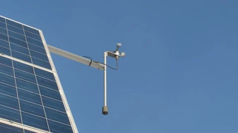 Solar energy panels with wind meter against blue sky Stock-Footage 171664298