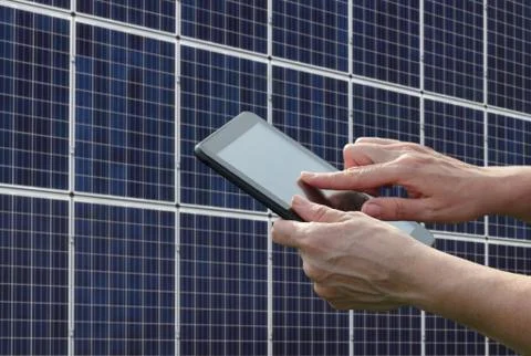 Solar energy, worker hands using tablet and panels 写真素材