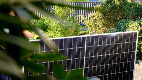 Solar energy.Solar panel in the hands of a worker in a summer garden. Stock Footage 196208258