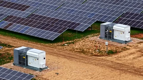 Solar Equipment Amidst Photovoltaic Array on Dirt Pathway Stock Footage 334933696