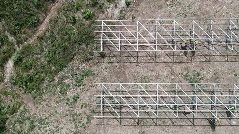 Solar farm construction with mounting frames beside vegetation Stock Footage 278367952