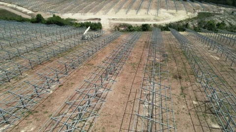 Solar farm construction site with mounting structures near a pond Stock Footage 278368152