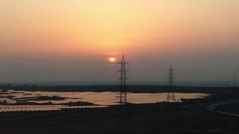 Solar-farm-drone-descending-sunset-transmission-towers Stock Footage 342804287