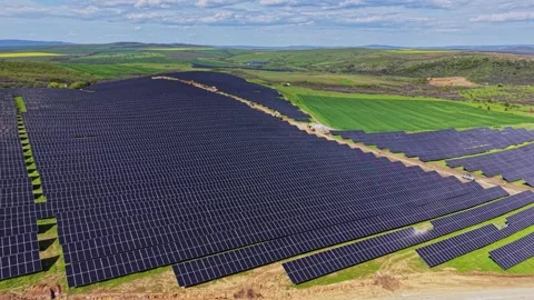 Solar farm installation in open field near hills in bright sunlight 스톡 동영상 338241475