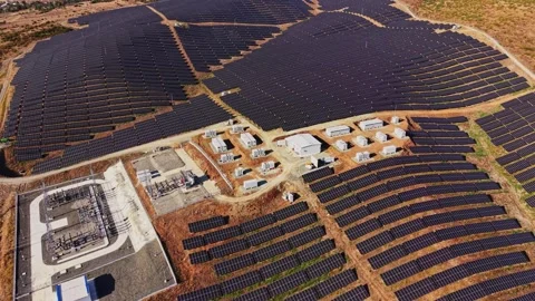 Solar farm located on a hillside with rows of solar panels in use Stock Footage 344540667