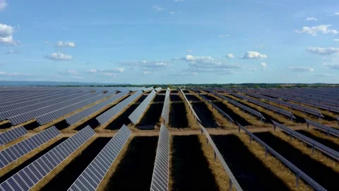 Solar farm: parallel rows solar panels, sun, shadows (color graded) Stock Footage 153942503