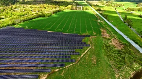 Solar Farm Pullback Green Agricultural Field Highway Latvia Renewable Energy Video stock 334691392