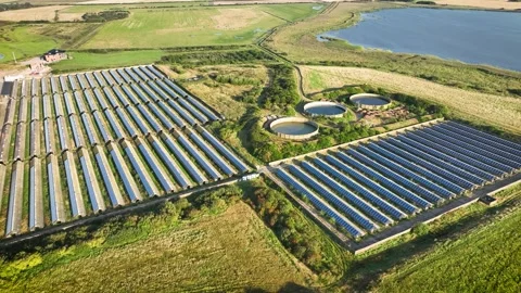 Solar farm with rows of solar panels installed on roofs of farm. Stock-Footage 285593315