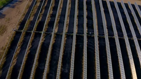 Solar farm: side movement overhead rows of solar panels (color graded) Stock Footage 153942486