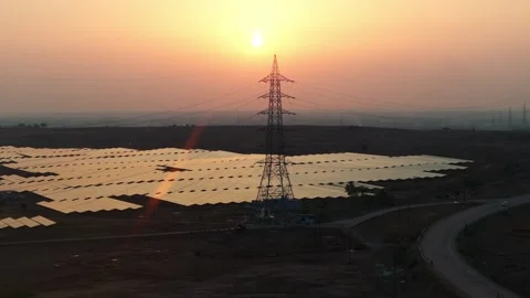 Solar-farm-transmission-tower-drone-forward-flight-golden-hour Stock Footage 342804316