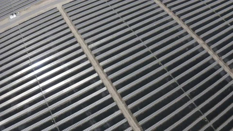 Solar farm: wide pullback over solar panels tilt up to sky (ungraded, log gamma) Stock Footage 153929360