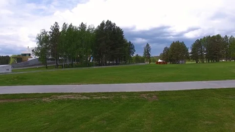 Solar Golf cart with clouds on blue sky and forest lake Golf club, aerial Stock Footage