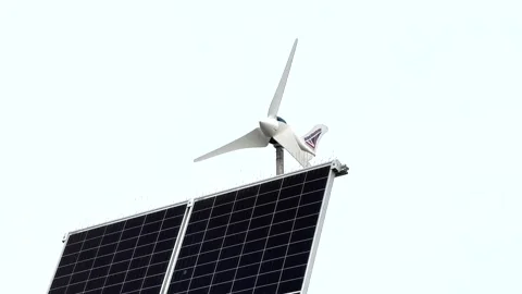 Solar panel and small wind turbine powering street light on pole Stock Footage 220126628