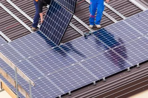 Solar panel and workers. Stock Photos
